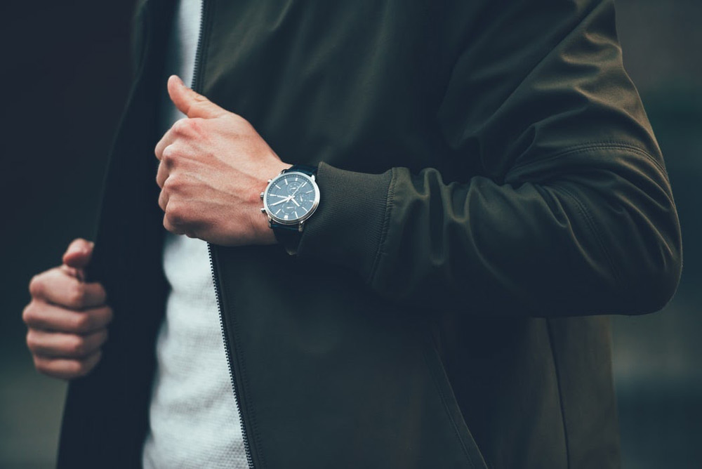 A man wearing a casual jacket with his everyday luxury watch