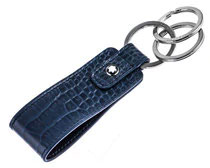 A high-end men’s gift of a black leather keychain fob attached to three silver keyrings