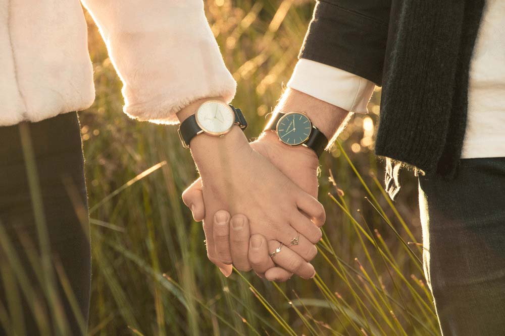 A couple wearing luxury watches.